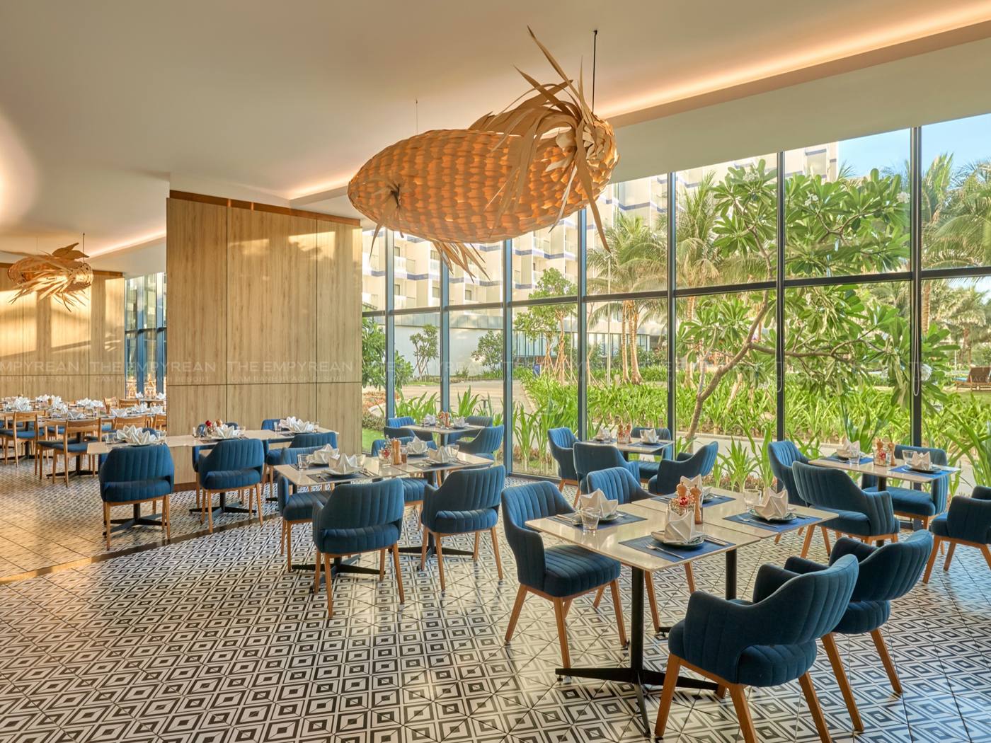 Bright restaurant with tall windows onto the palms