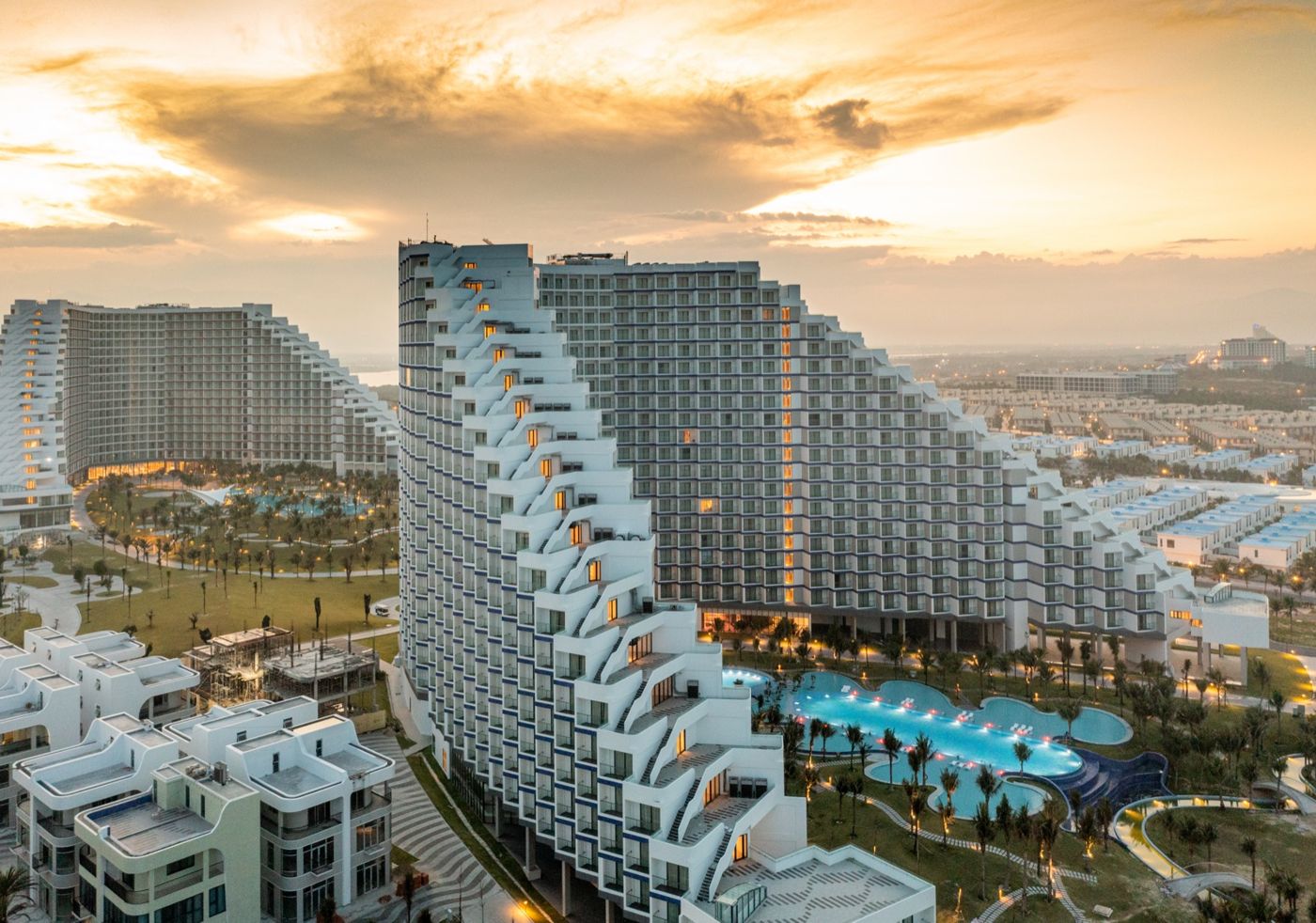 The terraced towers in warm golden light under an amber sky over the land