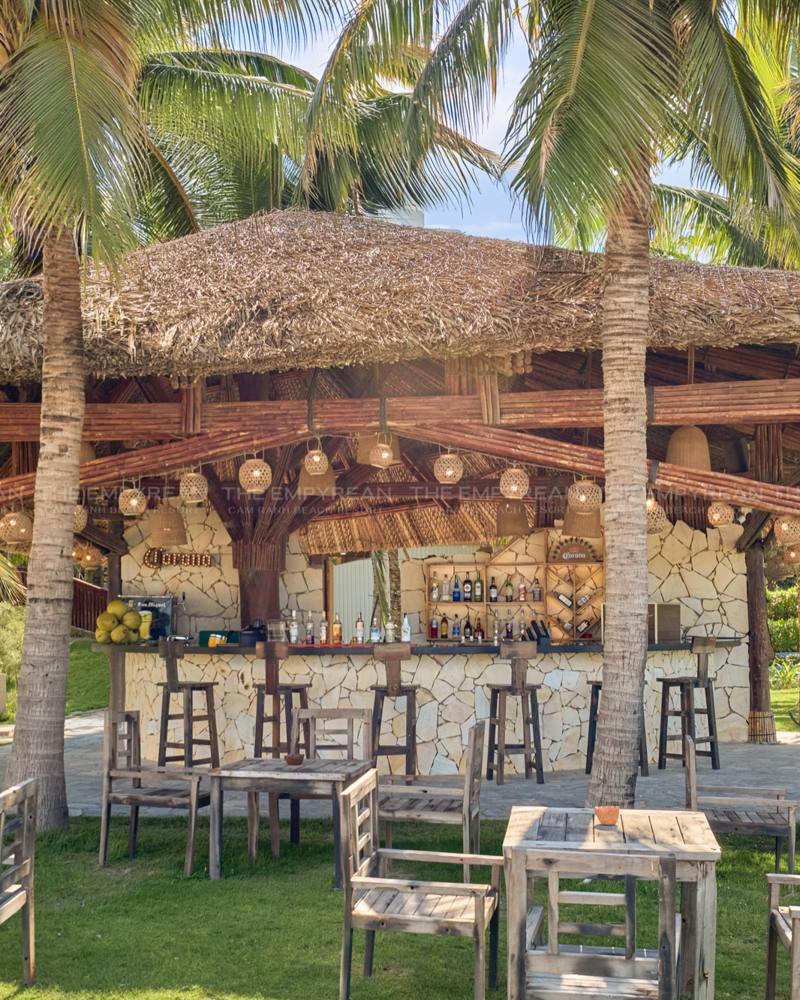Thatched garden bar under palm trees